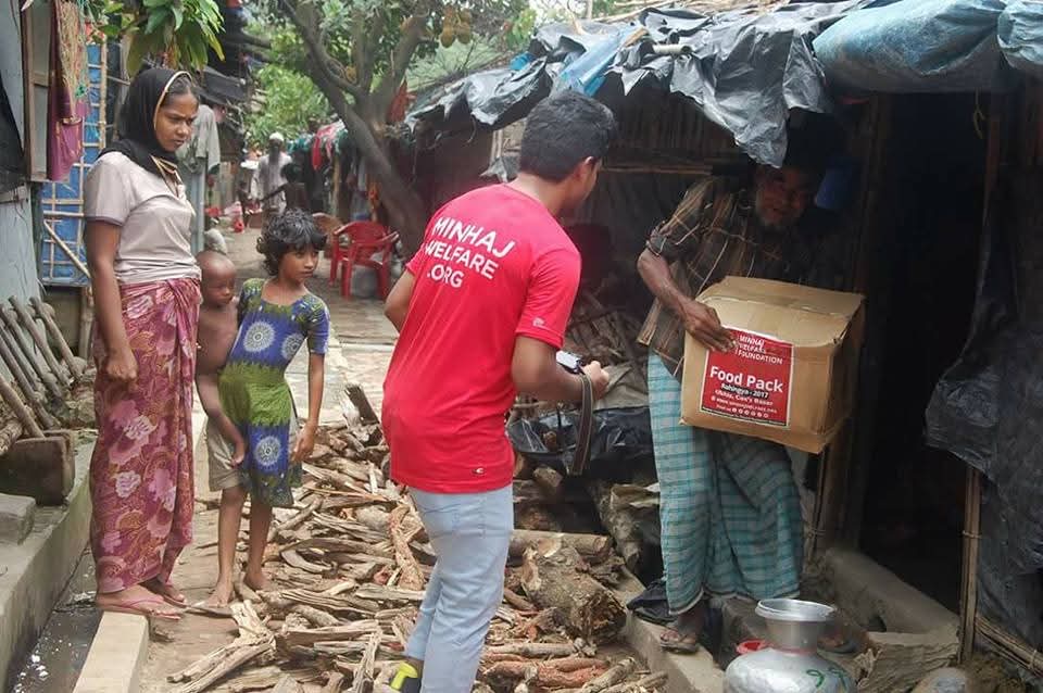 A volunteer delivering essential supplies directly to a family in Bangladesh