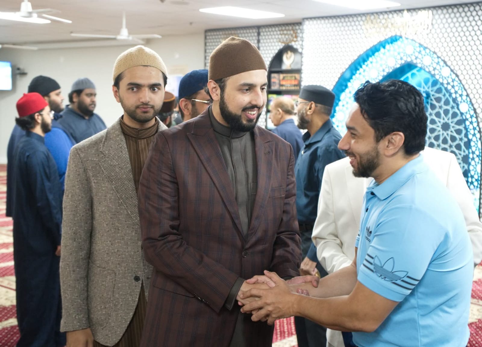 Syed Najam in conversation with a community member in Canada